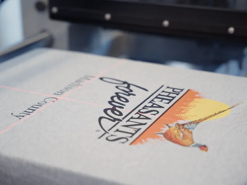 DTF transfer being pressed onto shirt with laser alignment